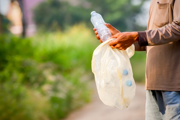 Person collecting plastic bottles to recycle