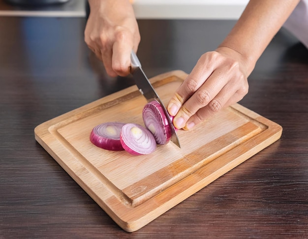 Photo a person cutting onions on a cutting board with a knife