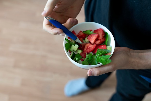 A person eatng healthy raw organic salad sport fitness diet