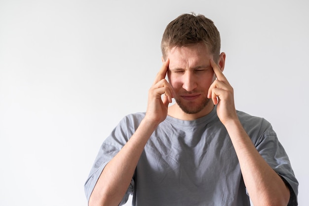 A person feeling headache and touching head with his hand