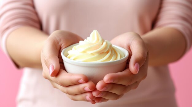 Photo a person gently holds a white bowl filled with creamy soft serve dessert showcasing a delicious swirl of flavor against a soft pink backdrop