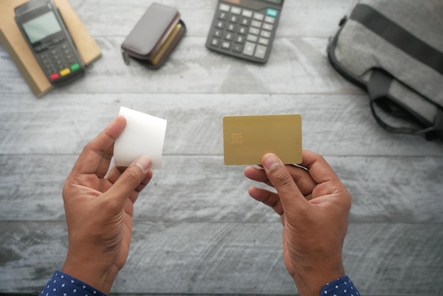 Person hand holding credit card and bill paper