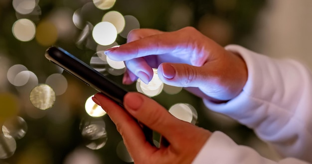 Person hand holding smartphone and typing message on mobile device human and modern technologies