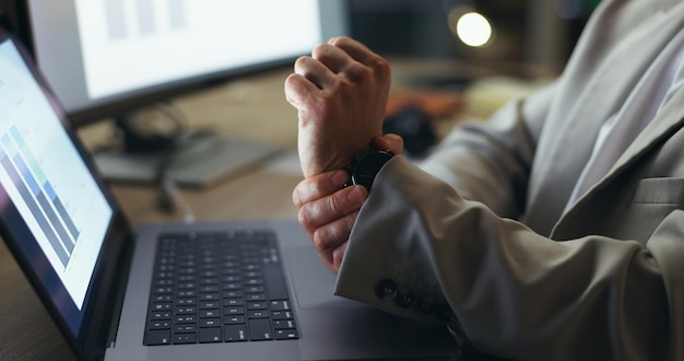 Person hands and night with laptop for wrist pain injury or arthritis at office desk Closeup of employee working late with sore muscle joint ache or carpal tunnel syndrome for strain at workplace