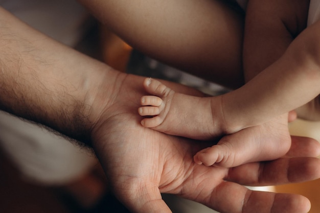 a person holding a babys hand with the word quot on it