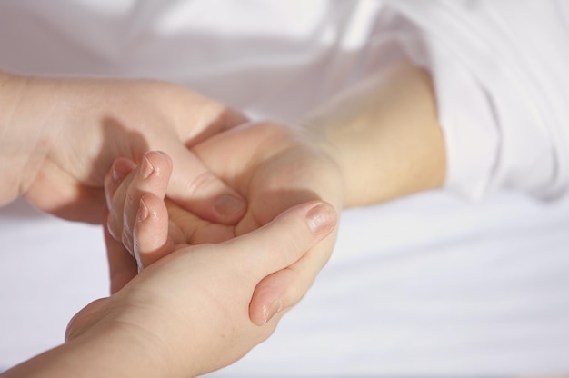 a person holding a bandaged hand with a bandaged hand