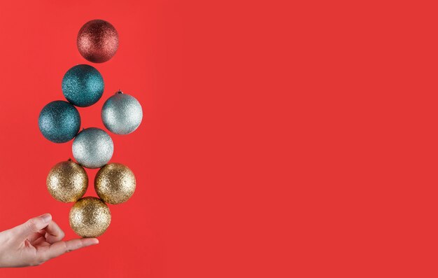 Person holding Christmas spheres striking a balance