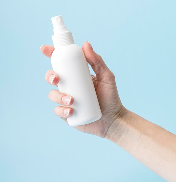 Person holding disinfection bottle