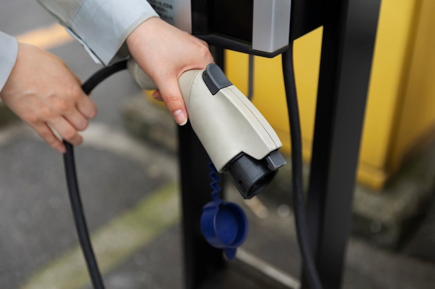 Person holding electric car charger