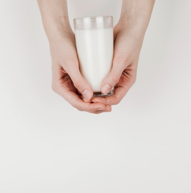 Person holding a glass of milk