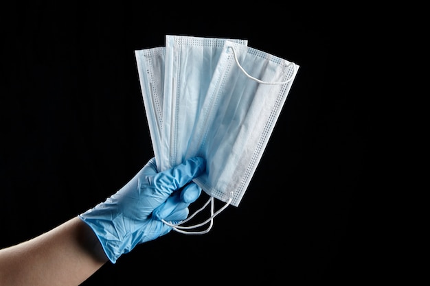 Person holding medical face masks