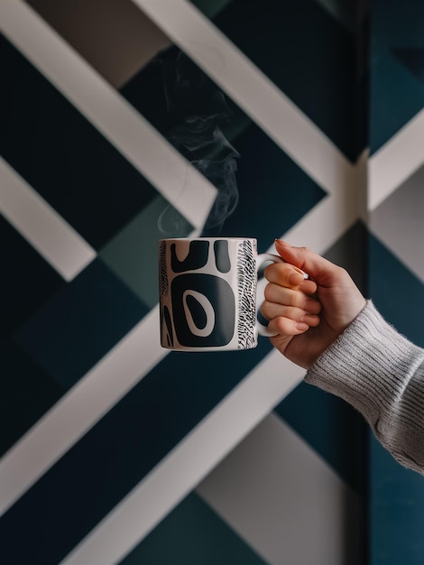 a person holding a mug