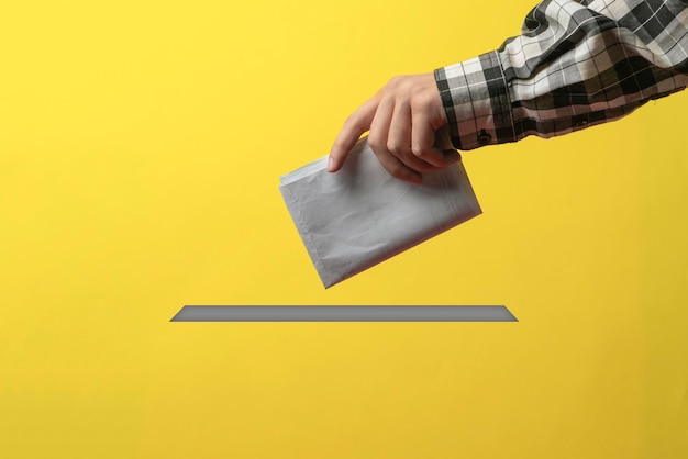 A person holding a paper bulletin and drop it in the urn minimalistic vote concept