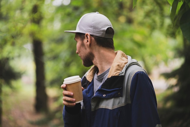 A person holding take away paper cup with hot drink