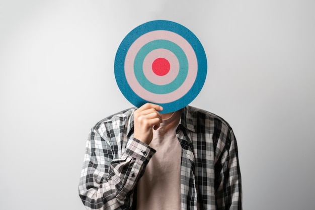 A person holding target in front of head internet sales targeting concept