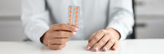 Person holds blister with medical pills selection and search for quality pills concept