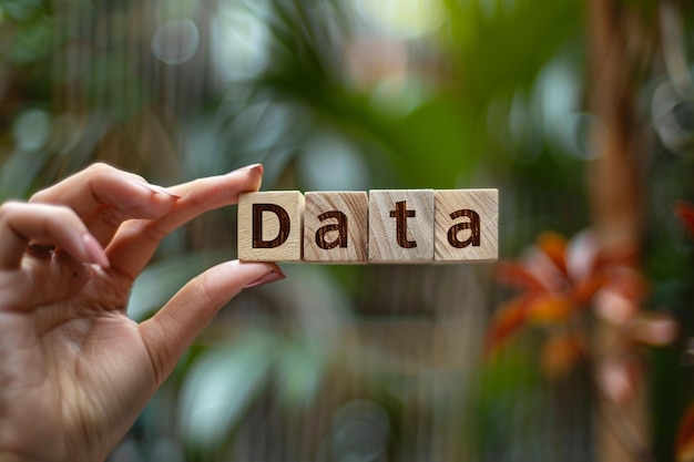 Photo a person holds a wooden block that says data in the background