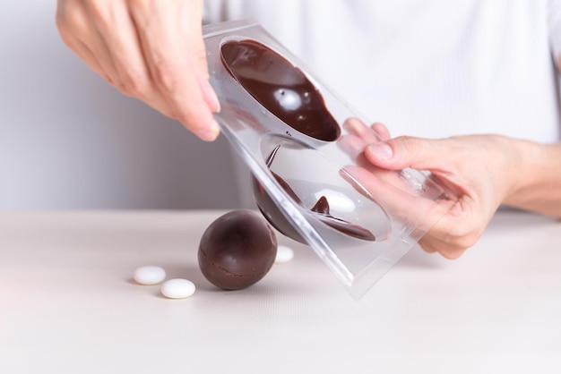 a person is holding a box of chocolates and chocolates