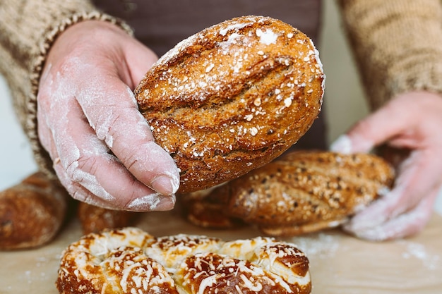 A person is holding a loaf of bread with the word bread on it.