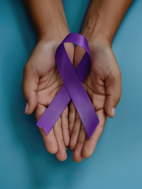 A person is holding a purple ribbon in their hands