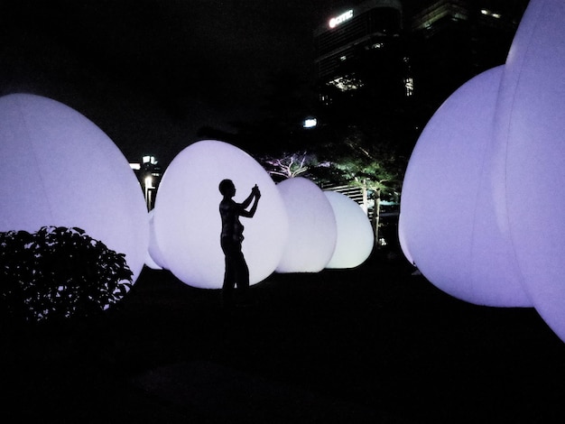 a person is silhouetted against a light that is lit up