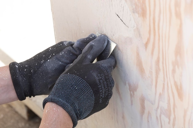 A person is using a piece of wood to cut a piece of wood.