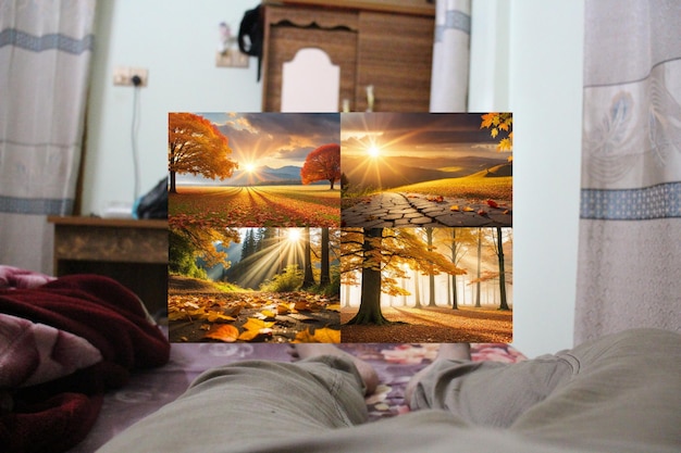 A person laying on a bed with a painting of a forest and the sun is shining on the screen.