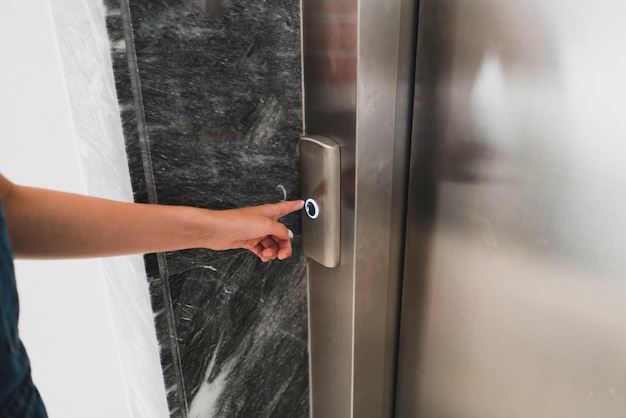 A person in the lift elevator pushing the button