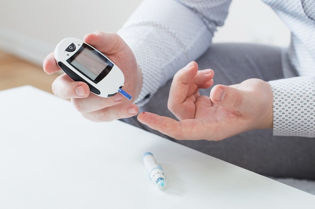 Person measures blood sugar with glucometer