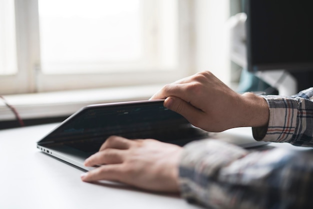 A person opens laptop computer to do some online work on project