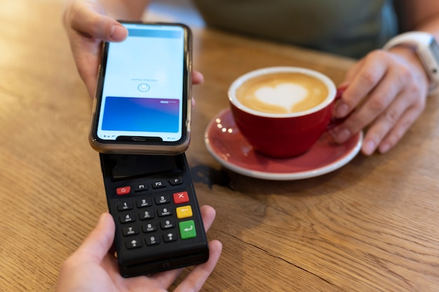 Person paying with its smartphone wallet app