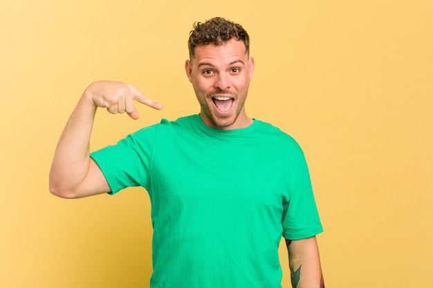 Person pointing by hand to a shirt copy space proud and confident