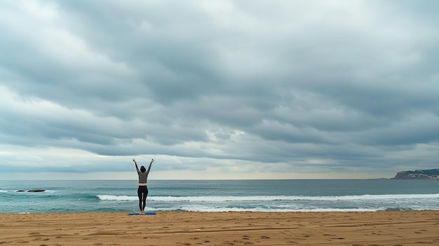 Person practicing yoga on beach