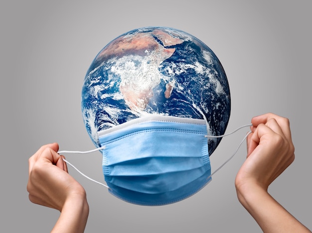 Person putting a medical mask on earth