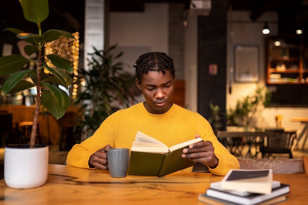 Person reading a book in a cafe