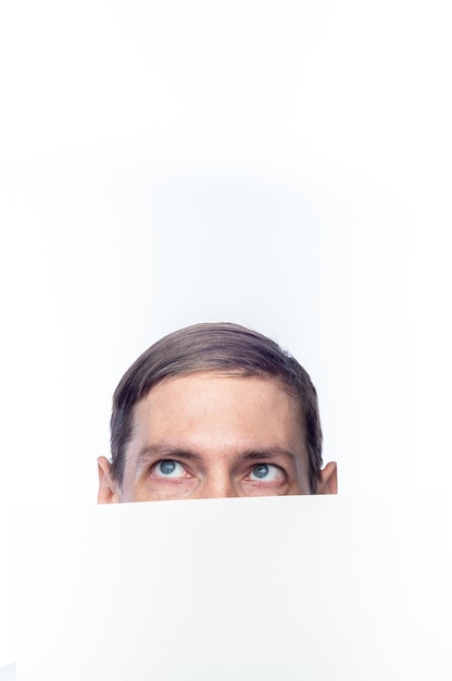 The person's face is covered with a white piece of paper on an isolated backgroundxA