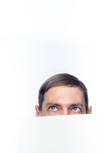 The person's face is covered with a white piece of paper on an isolated backgroundxA