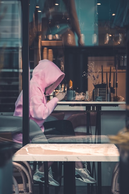 A person sitting at a table in a cafe