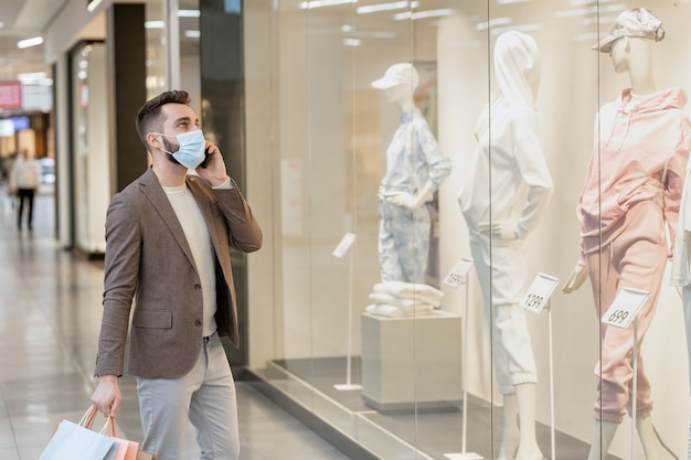 A person talking on a cell phone during shopping