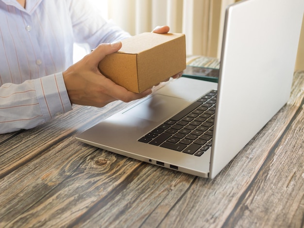 Person teleworking with online order box in front of the computer