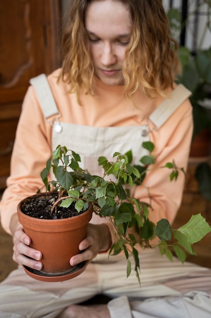 Person transplanting plants in new pots