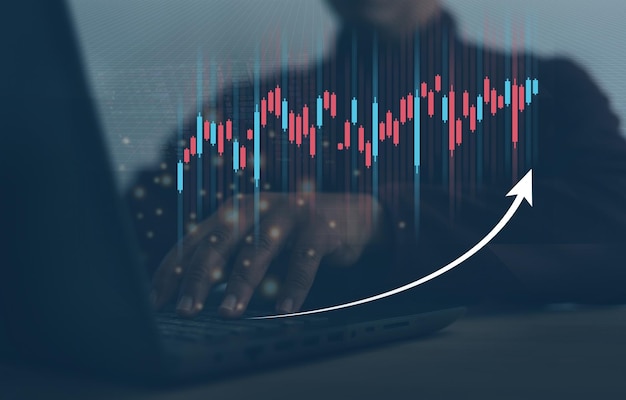 A person uses a laptop to checking analyzing sales data growth graph chart and stock market