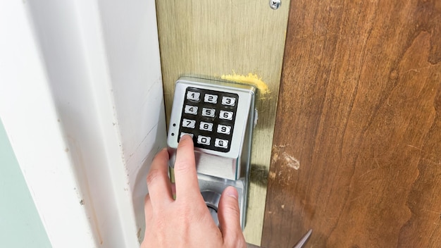 A person using a lock that is open to a door.