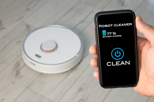 Person using the remote control of a Robotic Vacuum Cleaner on their smartphone