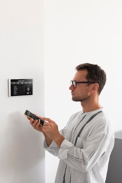 Person using a smartphone in an automated home