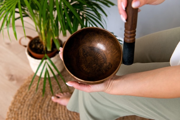 Person using tibetan singing bowl