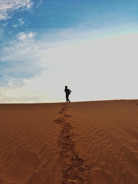 Person walking footprints in desert