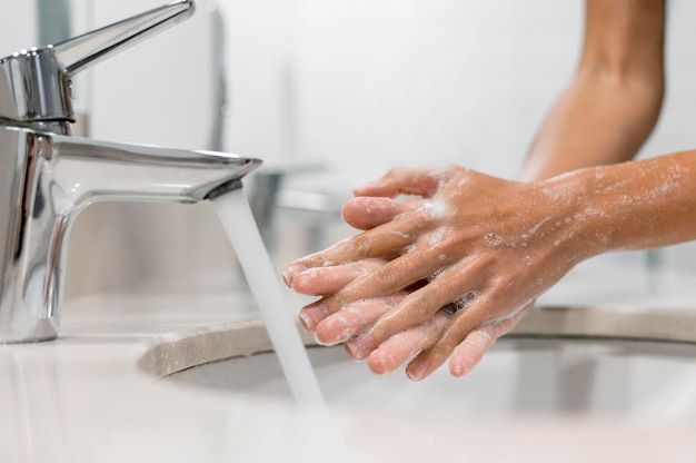 Person washing hands with soap