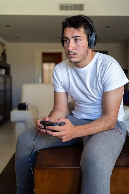 Person wearing headphones and playing video games on TV