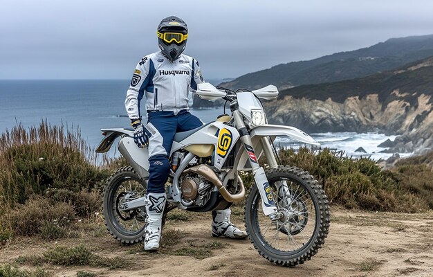 Photo a person wearing a helmet and goggles stands on a dirt bike